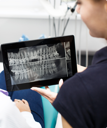 two-woman-look-at-the-tooth-picture-on-a-tablet-at-dentist-office